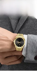 Close-up of golden stainless steel watch with black dial and day-date display