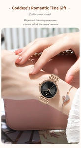 Rose gold mesh watch with black dial and swan bracelet on woman wrist with pink bag