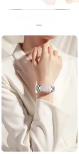 Close-up of Hannah Martin square silver watch with tiffany blue dial on woman's wrist