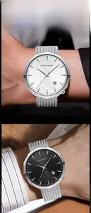 Wrist shot of octagonal stainless steel watch with mesh band and date display