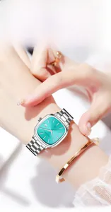 Fashionable women's square silver watch with Tiffany blue dial on a model wrist