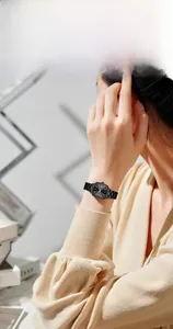 Detail of a minimalist black square steel watch for women with stylish metal strap
