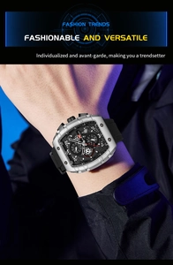 Close-up of a men's silver tonneau quartz watch with black silicone strap on a wrist