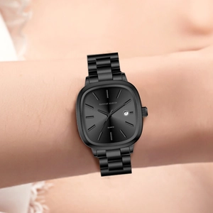Women's minimalist square black dial watch with steel strap and date window on wrist