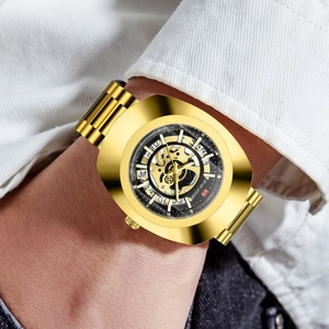 Men's gold tonneau mechanical watch with skeleton dial and stainless steel band on wrist