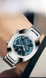 Detailed view of polished oval stainless steel case and blue sunray dial on men's wrist