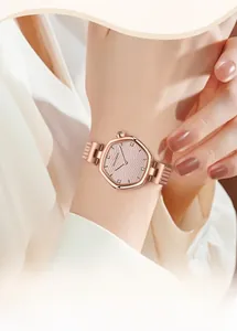 Detailed macro view of the rose gold hexagonal watch face with textured dial and crystals