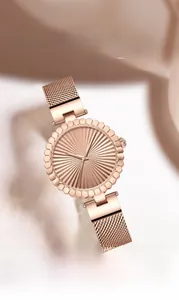 Detail of rose gold sunray dial and petal-cut bezel on women's steel mesh strap watch