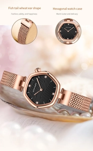 Detail of rose gold hexagonal watch with black wave dial and mesh strap on pearls