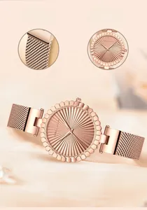 Detail view of rose gold stainless steel watch with mesh band and textured sunray dial