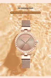 Macro shot of rose gold watch dial with sunray texture and Milanese mesh strap