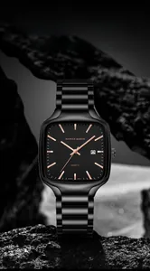 Detail of square quartz watch face with luminous hands and date window on black stone