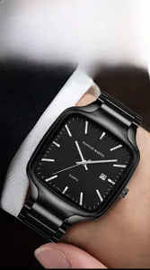 Close-up of black square quartz watch with date window worn with business suit
