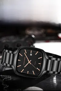 Macro shot of square quartz watch with luminous calendar display and rose gold markers