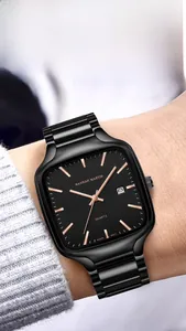 Detailed close-up of a black square quartz watch with rose gold indices on a wrist