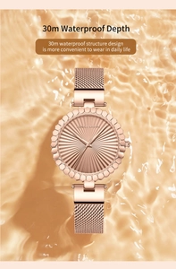 Detailed view of Hannah Martin rose gold watch with 30m water resistance over water ripples