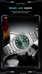 Detail of silver stainless steel watch with green dial and double calendar display