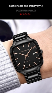 Close-up of black square quartz watch with rose gold markers on a male wrist