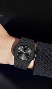 Close-up of black men's sports watch with octagonal matte case and date window display