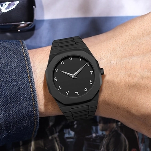 Close-up of matte black octagonal men's watch with Eastern Arabic numerals on the wrist
