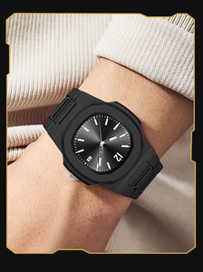 Close-up of black octagonal quartz sports watch with textured dial and date display