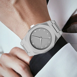 Detail shot of grey octagonal quartz watch with Arabic numerals on man's wrist
