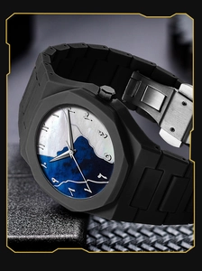 Detail shot of matte black octagonal watch bezel with Arabic numerals and marble dial texture