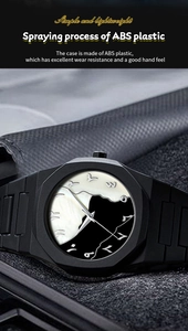 Detail showing matte black octagonal watch bezel with mountain and bird art dial