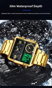 Montre numérique carrée dorée étanche immergée dans l'eau sur des rochers noirs