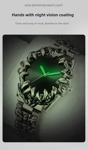 Detail of luminous green hands on gothic claw bezel watch with dark metal finish