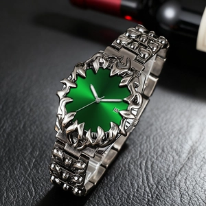 Unique claw-shaped silver watch with green sunburst dial and flame-like bezel design
