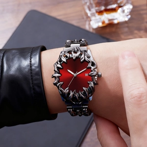 Gothic style men's watch featuring silver flame claw bezel and deep red dial on wrist