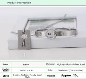 Macro detail of stainless steel heart lock bracelet and key necklace set with small crystals
