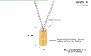 Rotating stainless steel necklace pendant with gold finish and engraved sutra details
