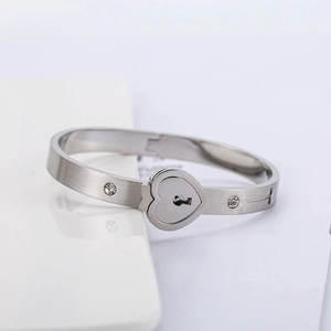 Polished heart lock stainless steel couple bracelet with sparkling cubic zirconia stones