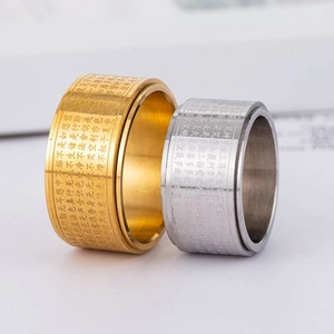 Anelli rotanti in oro 18K e acciaio inossidabile con incisioni di sutra buddisti