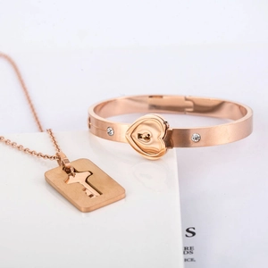 Rose gold heart lock bangle and key necklace set with sparkling crystal accents