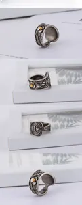 Detailed views of vintage stainless steel ring with embossed floral patterns and eagle crest