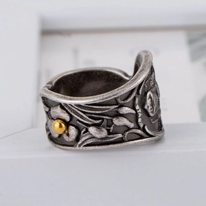 Vintage stainless steel wide band ring with embossed floral patterns and gold details