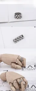 Detail shot of silver stainless steel watchband link ring on a wooden mannequin hand
