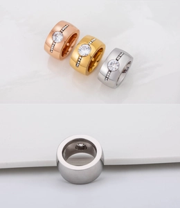 Detailed macro view of gold, rose gold and silver plated men's wide band rings with crystals
