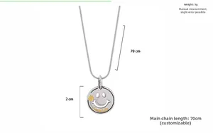 Detailed close-up of a silver smiling face pendant with clover pattern and Love Life engraving
