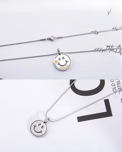Detail of smile face pendant with clover accent and Love Life engraving on steel chain