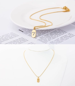 Detail of gold snake chain with lucky number 7 pendant shown on neck and flat lay