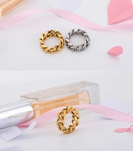 Close-up of gold and silver cuban link chain rings on a refined gift background