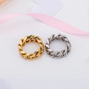 Minimalist punk style gold and silver cuban chain rings on a clean white background