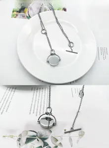 Détail du pendentif rotatif gravé Merci Paris et de la chaîne à fermoir OT