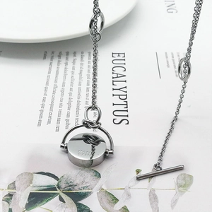 Collier long en acier titane argenté avec pendentif rotatif Merci Paris et fermoir T