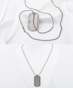 Detail of vintage square pendant on bead chain against silk and white model stand