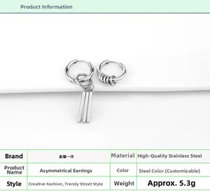 Detail of asymmetric stainless steel earrings featuring hoops and long cylindrical bars